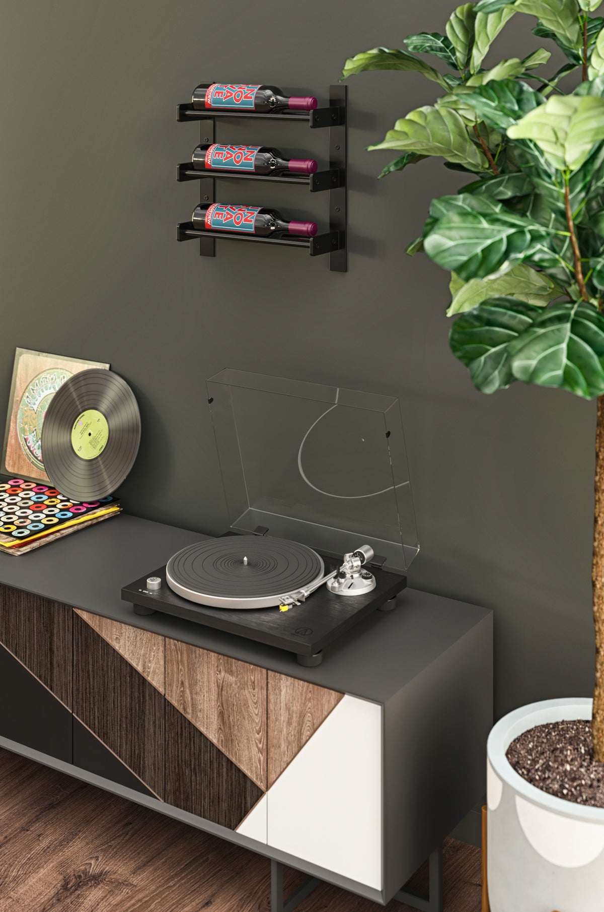 Compact wall wine bottle rack with three bottles next to a record player and turntable