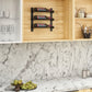 Wood cabinet wine rack wall with three bottles displayed on black shelf brackets