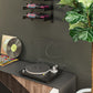Black wall wine bottle holder rack with three bottles and slanted support brackets