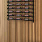 Wall-mounted wine bottle rack with dark shelves holding multiple bottles horizontally
