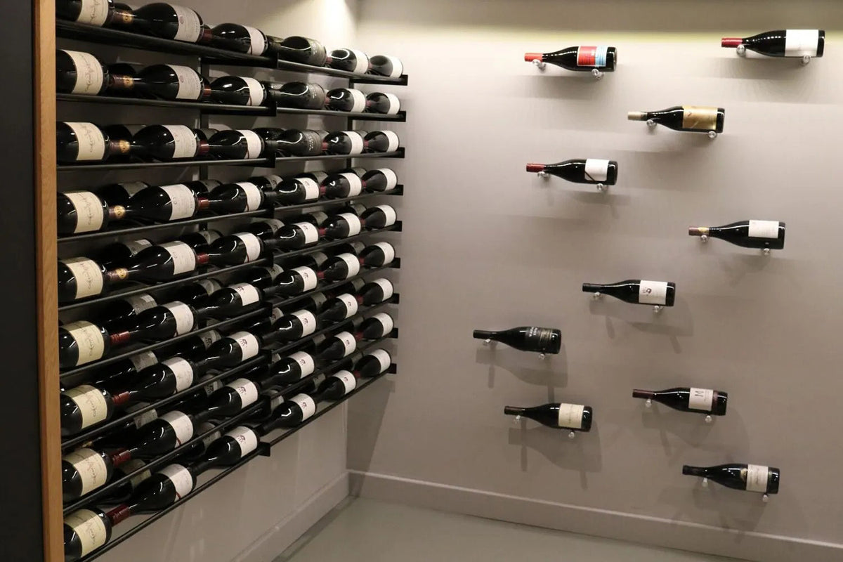 Wine bottle rack wall holding multiple dark wine bottles in a grid with black rails