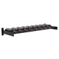 Wall-mounted wine bottle cork ledge with black frame and multiple purple-tinted bottles