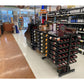 Double-sided wine bottle display rack with shelf, black metal, in-store bottle display on casters