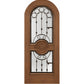 Warm brown wood wine cellar door with arched iron speakeasy grille and decorative inset panels