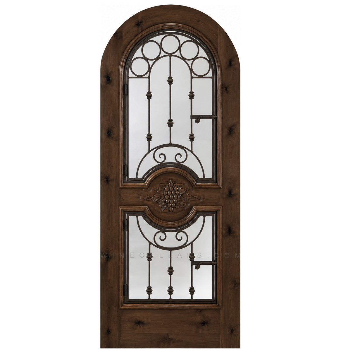 Dark brown wood wine cellar door with arched iron speakeasy grille and decorative inset panels