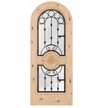 Natural light wood wine cellar door with arched iron speakeasy grille and decorative inset panels