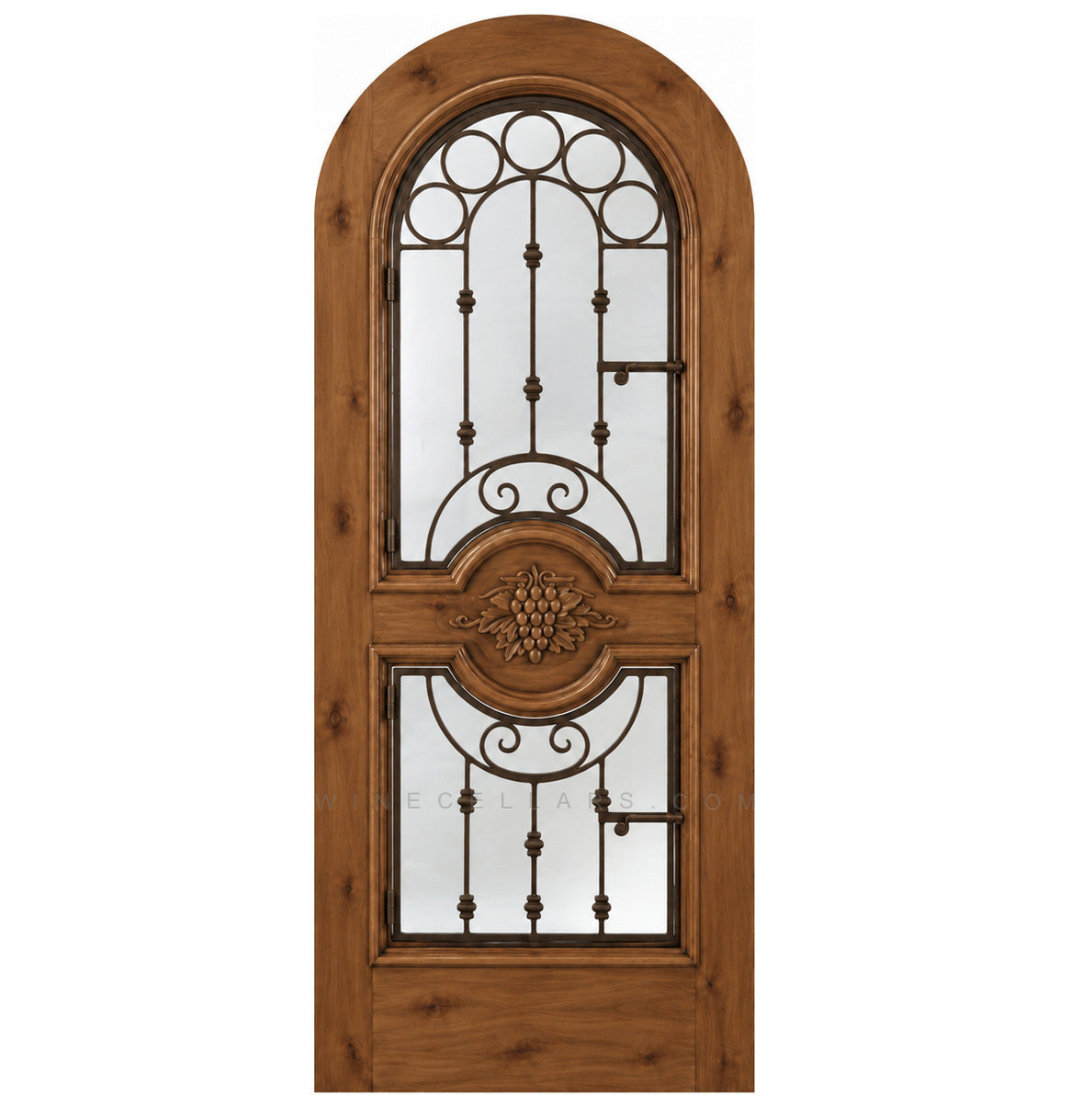 Honey-brown wood wine cellar door with arched iron speakeasy grille and decorative inset panels
