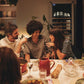 Goguette wine shelf insert shown inside a wine cooler at a dining table