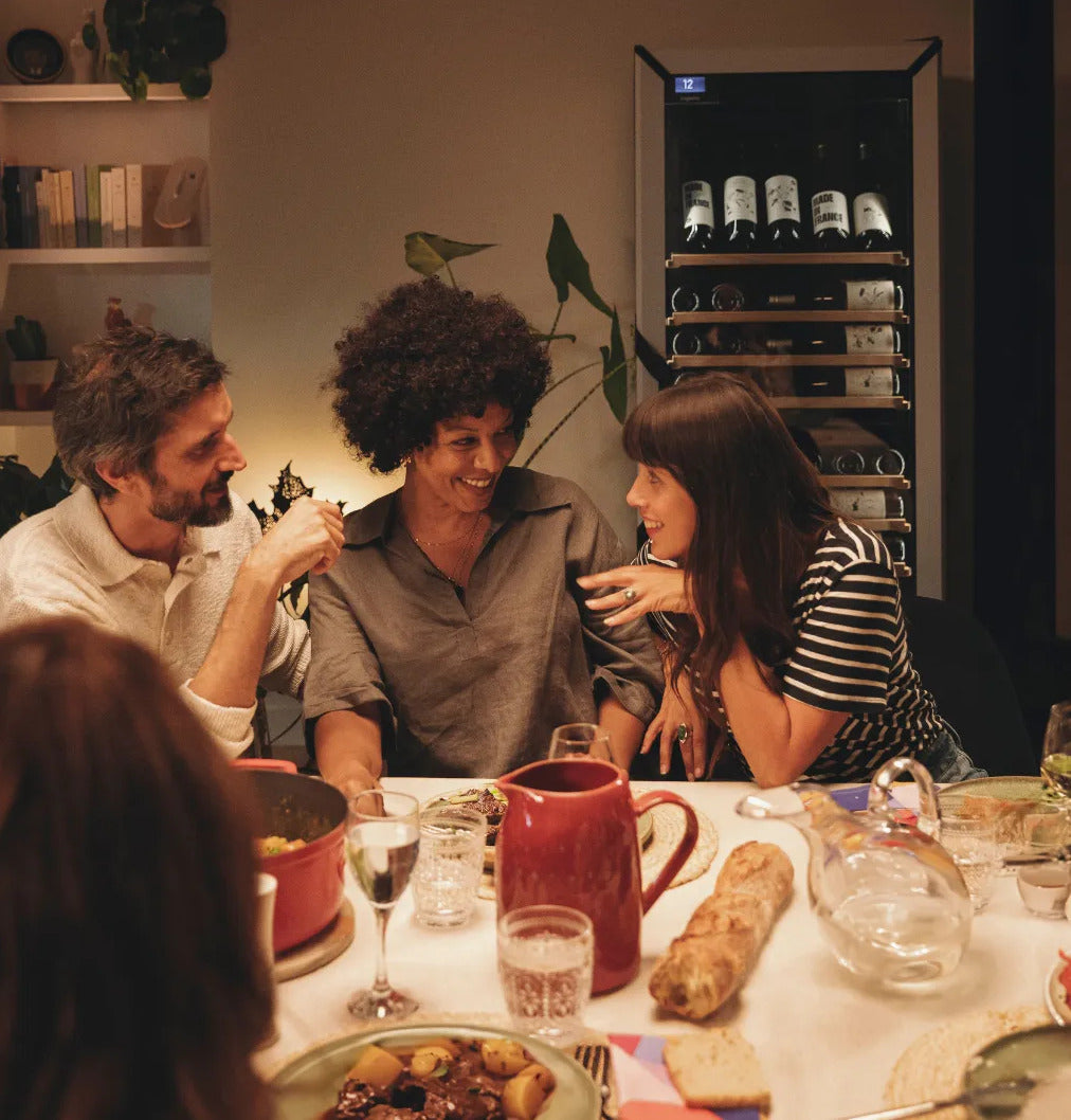 Goguette wine shelf insert shown inside a wine cooler at a dining table