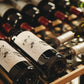 Wine bottles resting on wooden wine fridge shelves