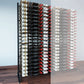 Double-sided wine bottle display rack with dark frame and multiple bottle rows