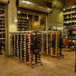 Wine rack extension with multiple tiers of wine bottles and a metal frame