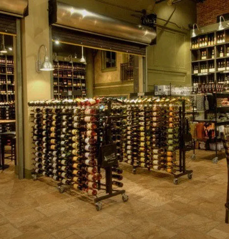 Wine rack extension with multiple tiers of wine bottles and a metal frame