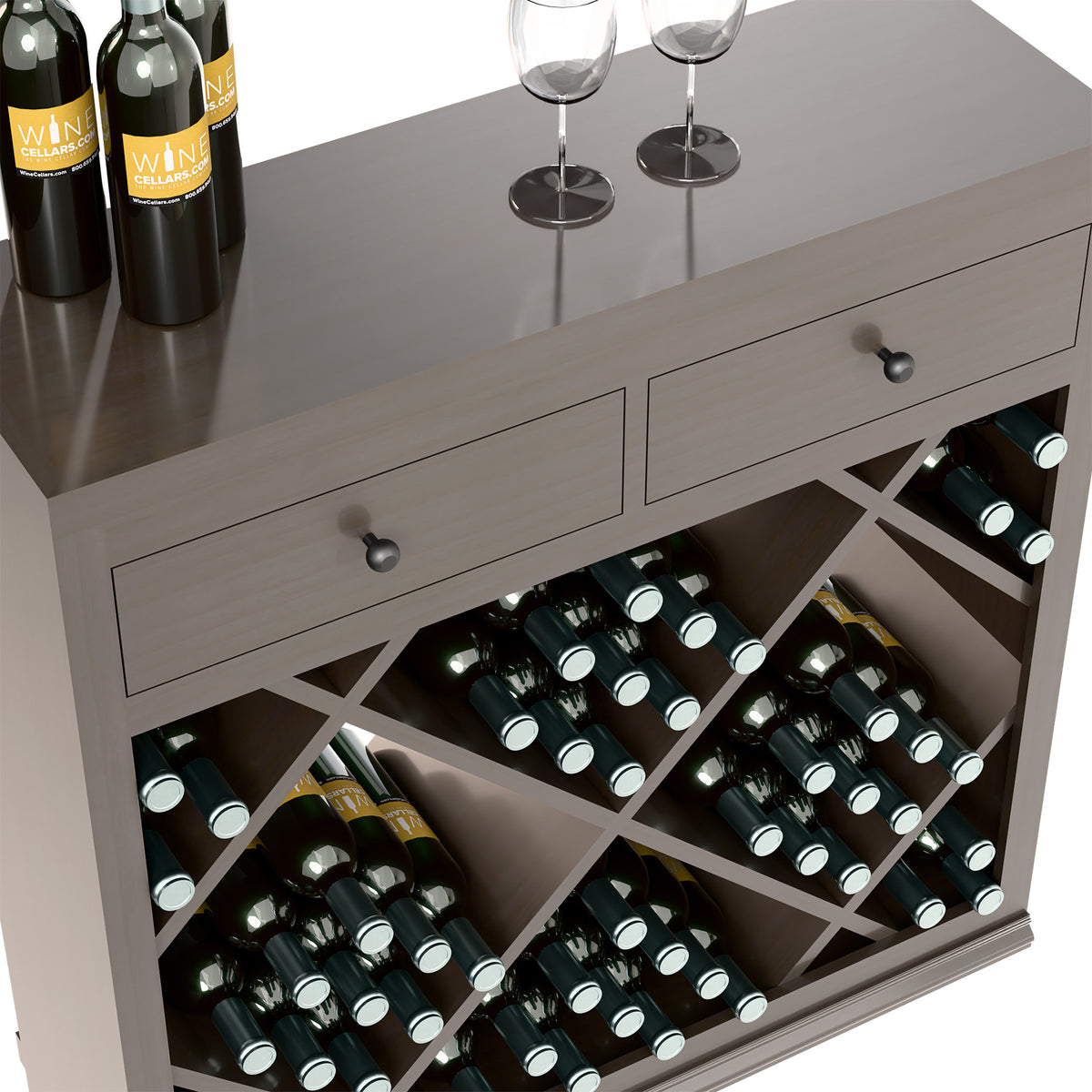 Close-up of two drawers and diamond wine rack holding bottles in wooden cabinet.