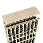 Wine rack top shelf in light natural wood with wine bottles in an 8-column grid