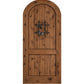 Arched-top warm brown wooden wine cellar door with centered wrought-iron speakeasy grate