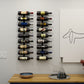 Wall-mounted wine rack holding wine bottles on a kitchen wall, countertop below