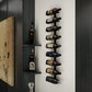 Wall-mounted wine bottle rack with black bottle holders