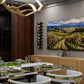Wall-mounted wine rack with gold frame and black bottle holders holding bottles