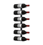 Wall wine rack with several wine bottles displayed vertically, red caps visible