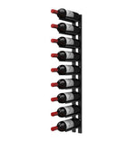 Black wall-mounted wine rack rail with multiple cork-out bottle pegs and dark bottles