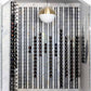 Black wine wall rack with many cork-out bottles on peg rails