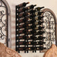 Black wall wine rack with decorative scrolls and cork-out bottle pegs