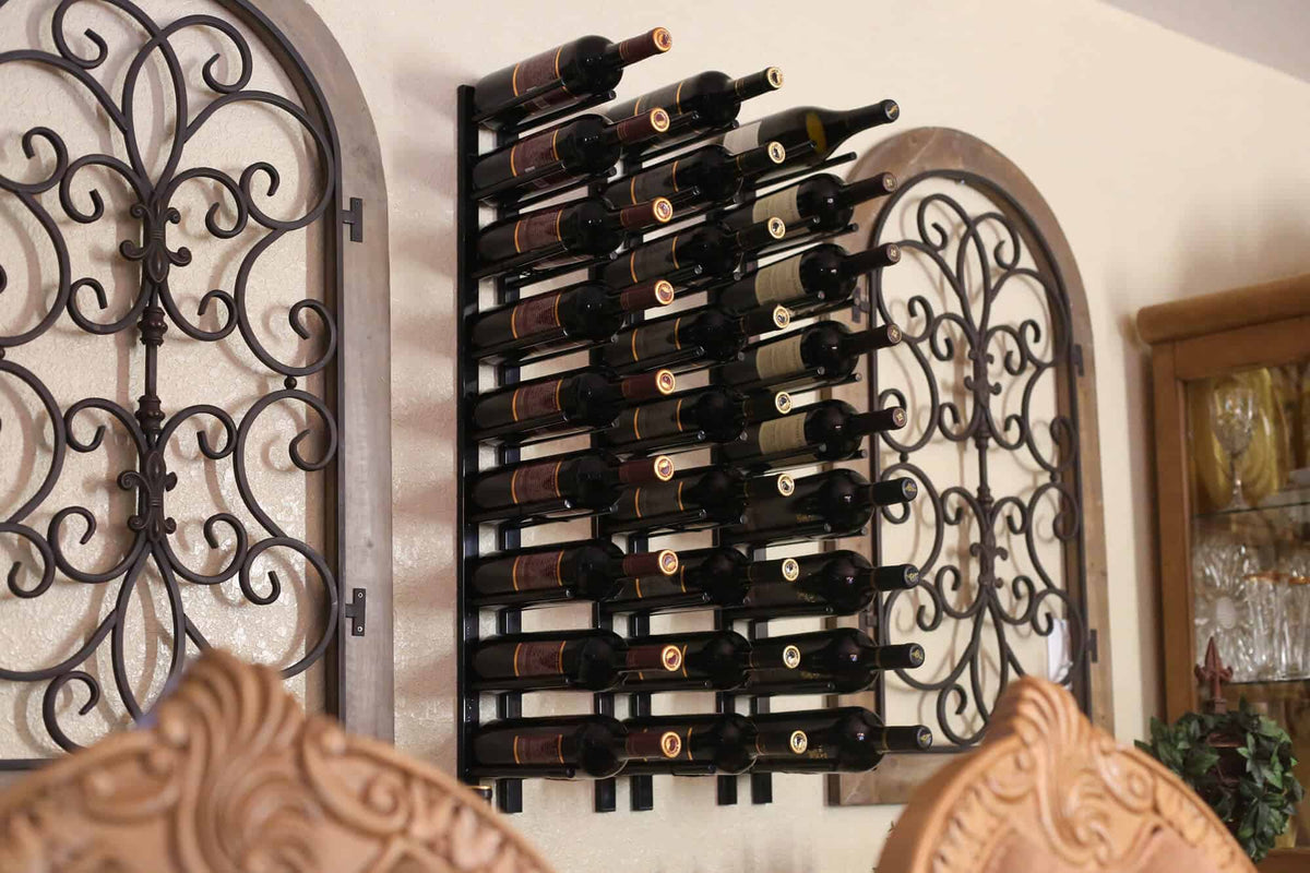 Black wall wine rack with decorative scrolls and cork-out bottle pegs