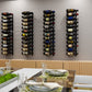Wall-mounted metal wine rack with several vertical sections holding dark wine bottles