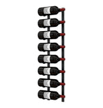 Wall-mounted wine rack with dark wine bottles and red bottle tips on black metal.