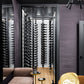 Wine storage wall with single-sided black peg rack for label-out bottle display