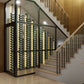 Wine bottle display cabinet with black frame and glass panels, label-out bottles by stairs