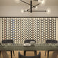 Wall-mounted wine bottle rack with cork-style pegs, filled with many bottles
