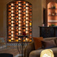 Arched double-sided wine rack with black backboard and cork pegs holding bottles