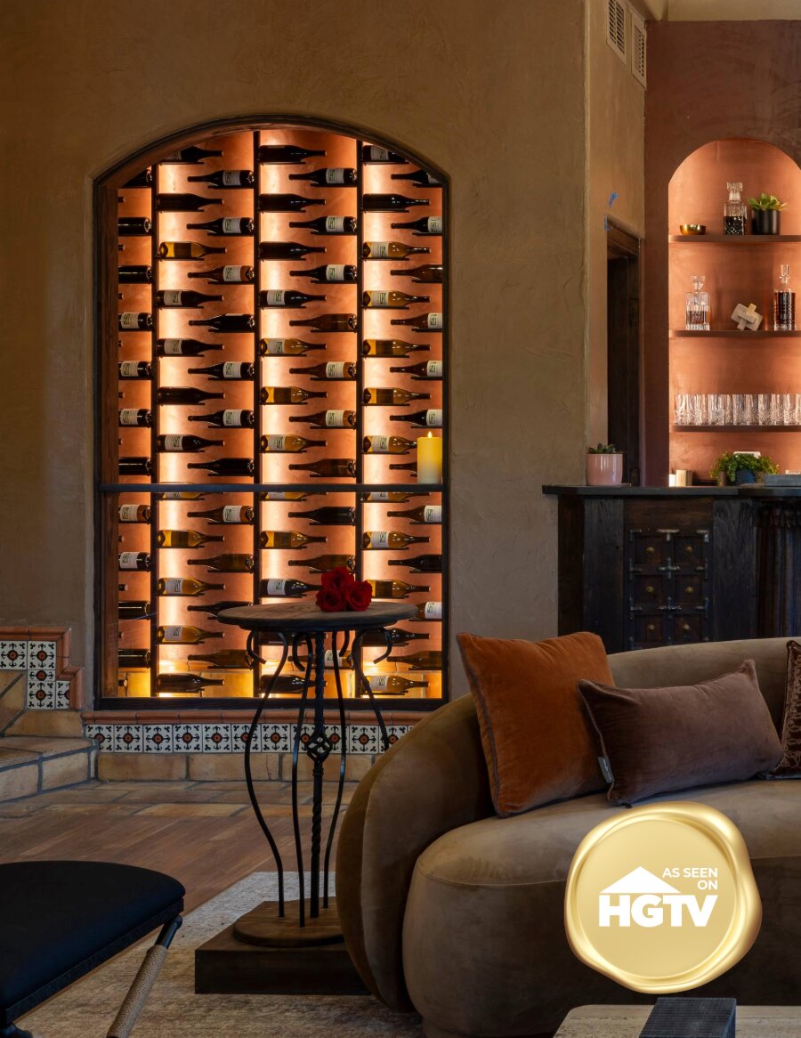 Arched double-sided wine rack with black backboard and cork pegs holding bottles