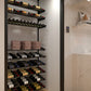 Wine storage wall rack with dark shelves holding bottles and paper boxes
