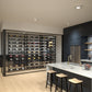 Wine bottle display wall kit with metal grid shelves and bar counter