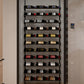 Built-in wine cabinet with black slat rack and bottles arranged on multiple levels