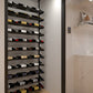 Wine storage rail kit in a built-in cellar with bottles on rails