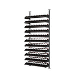 Black wine bottle display rack with many rows of dark bottles and visible labels