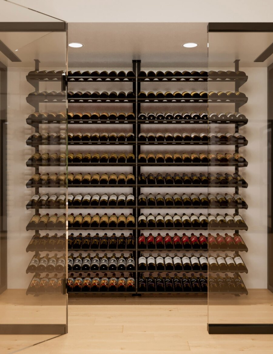 Wine bottle display rack wall with numerous tiers of assorted bottles behind glass
