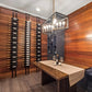 Interior wine bottle display wall with black peg racks holding label-out bottles