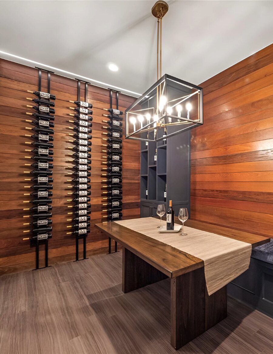 Interior wine bottle display wall with black peg racks holding label-out bottles