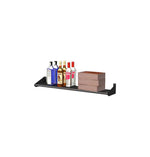 Black wall-mount liquor shelf holding bottles and a stacked wooden block divider