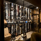Interior wine wall with black label-out bottle display rows and many front-facing bottles