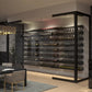 Wall-mounted label-out bottle display with multiple black shelves holding rows of bottles