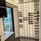 Wine peg wall with multiple bottle holders and hanging pegs