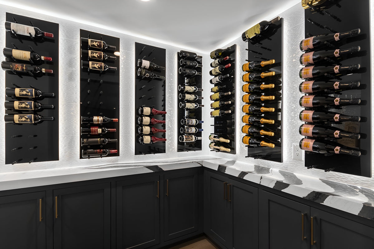 Black wine bottle wall panels with peg rails holding assorted bottles