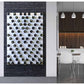 Wine bottle wall rack with white pegs, filled with mixed dark and light bottles