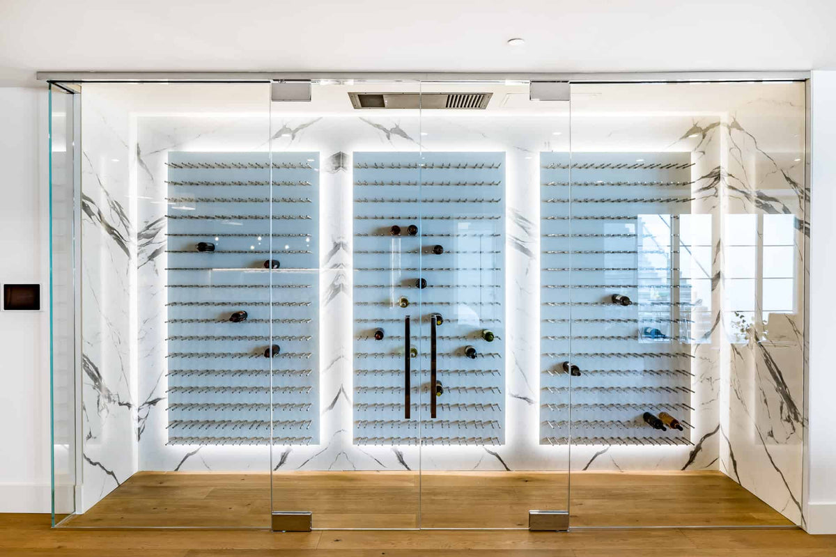 Wine bottle wall display with three white acrylic panels and rows of bottles on pegs